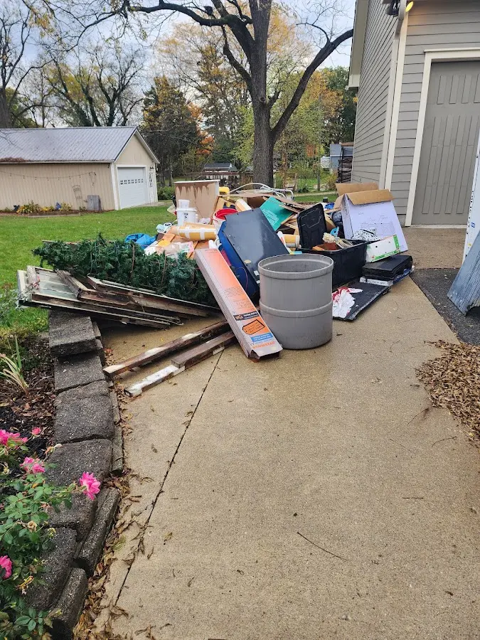 Dumpster being loaded with debris for Estate Cleanout Dumpster Rental in Armagh